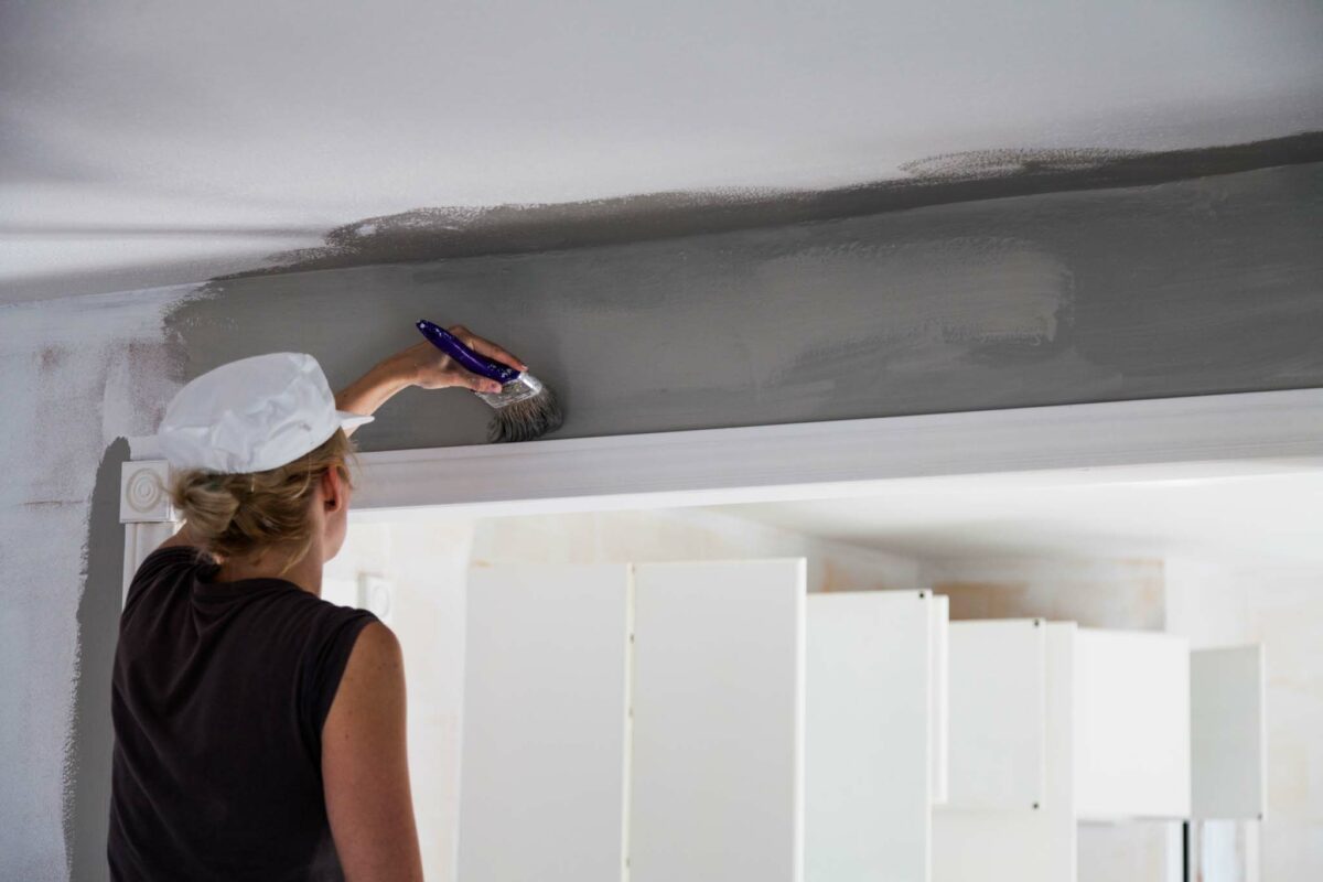 Woman Painting the Edges of the Ceiling