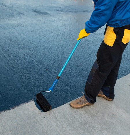 expert waterproofing the roof of a commercial building